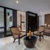 Kelapa Retreat & Spa in Pekutatan guest suite with seating area and bed against textured accent wall