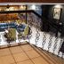 Gran Hotel Paris in La Ceiba lobby with ornate railing, seating area and tiled floor