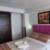 El Mirador de Santa Ana Cusco guest room with pink tufted headboard and neatly made bed
