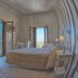 Relais La Pretura Vieste bedroom with twin beds and balcony doors overlooking the town