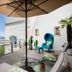Hotel Murtenhof & Krone terrace with lake view, lounge chairs, and umbrella in Murten