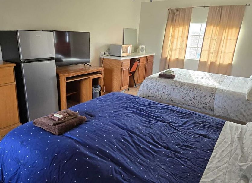Mountaineer Motel in Mount Storm: room with two beds, mini fridge, TV, microwave and window curtains