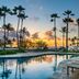 Hilton Garden Inn Kauai Wailua Bay in Kapaa with palm-lined pool and sunset ocean view