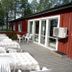 Örnvik Hotell & Konferens terrace with outdoor tables and chairs by a red building in Luleå