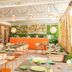 Vip Executive Picoas Hotel restaurant in Lisbon with bright seating, green tableware and a bar