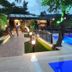 The Sarigerme Inn in Sarigerme with illuminated outdoor pool and deck at dusk