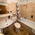 Yeti City Hotel Saarbrücken bathroom with bathtub, shower, sink and toilet in Saarbruecken