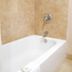 Airport Inn Downtown Phoenix bathroom with white bathtub and beige tile walls