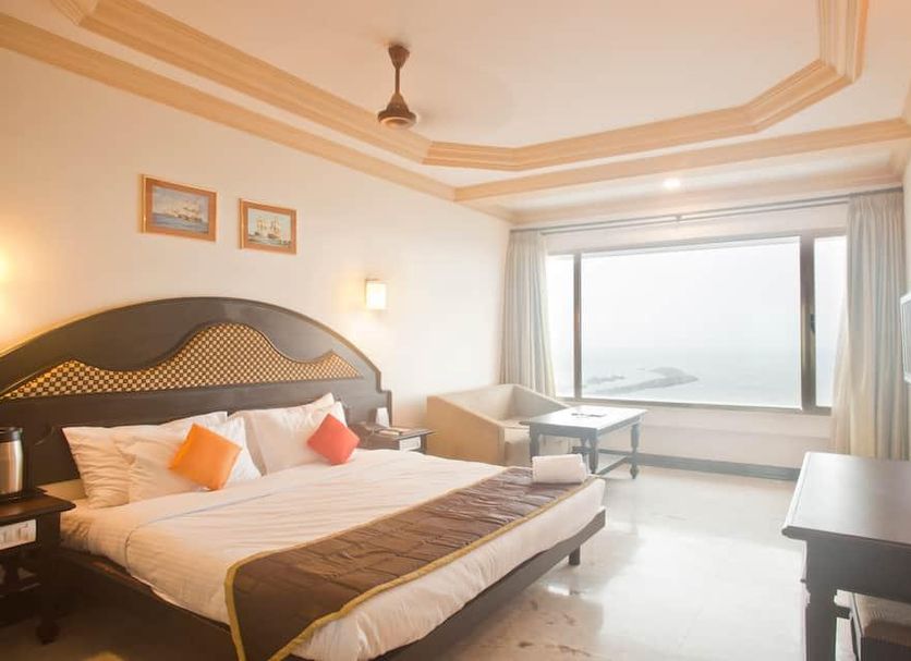 Hotel Sea View in Kanyakumari guest room with large ocean-view window and king bed