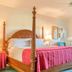 Sea Cliff Gardens Bed & Breakfast in Port Angeles: four-poster bed with pink quilt in a bright guest room