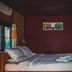 Kalm Pai guest room in Pai with a double bed, colorful wall art, and windows with natural light.