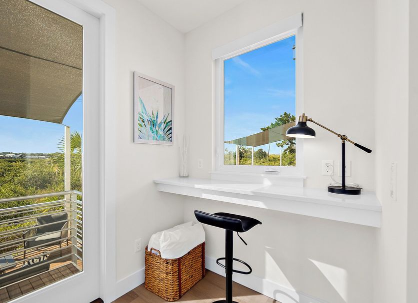 St Francis Inn in St. Augustine: bright guest room nook with desk, stool, and balcony view