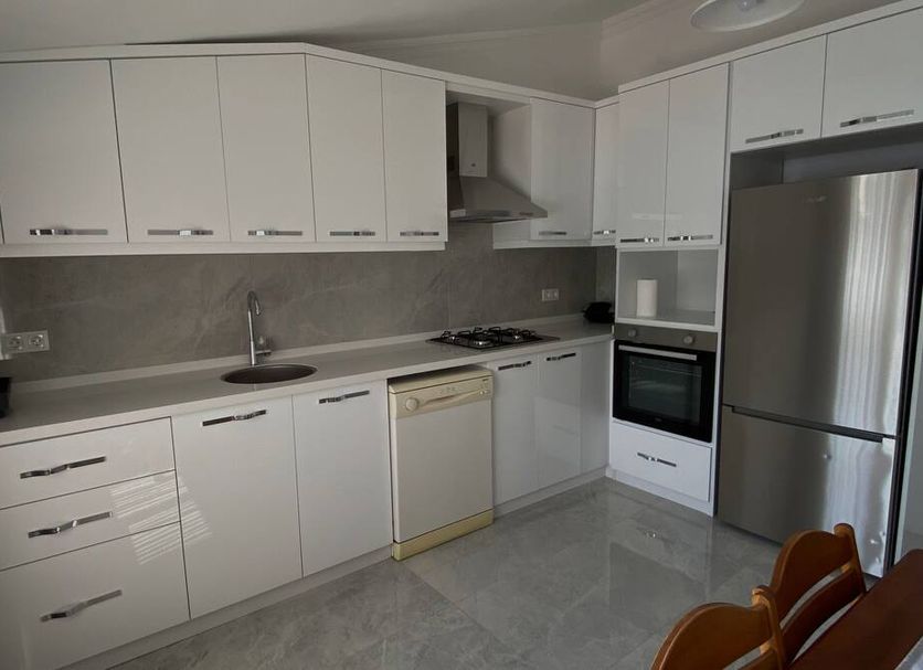 Hotel Melisa in Bozburun kitchen with white cabinets, stainless steel fridge, oven, and cooktop