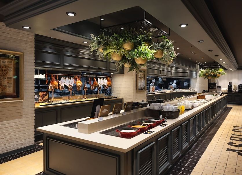 Kensington Resort Gyeongju buffet dining area with a long serving counter and hanging greenery in Gyeongju