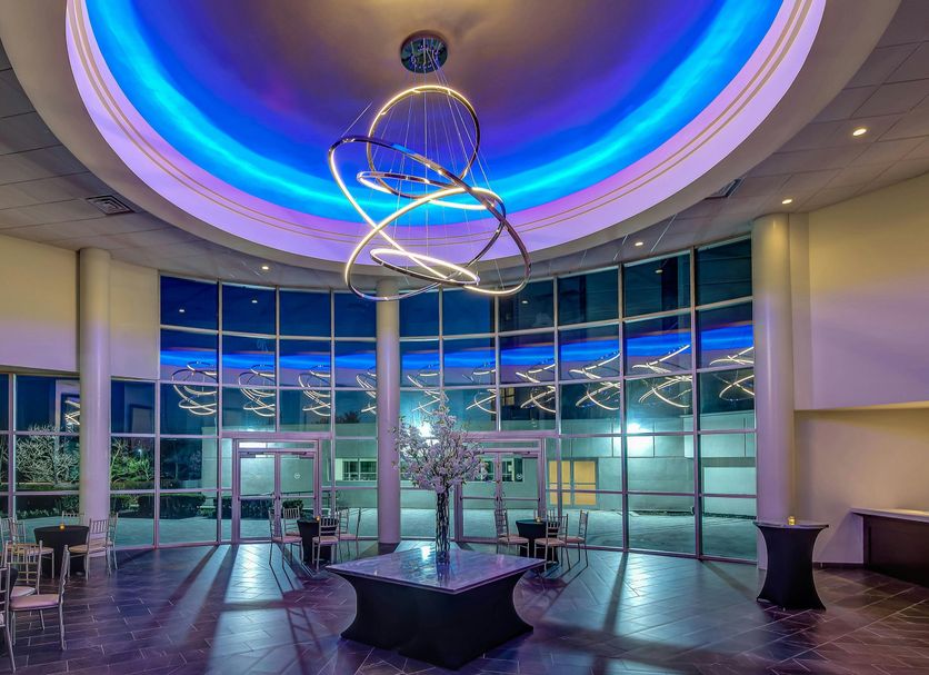 Sheraton Eatontown Hotel lobby with blue-lit circular ceiling and modern chandelier in Eatontown