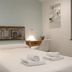 Hotel San Nikolas Sea Views room in Hondarribia with a double bed, bedside lamp, and folded towels