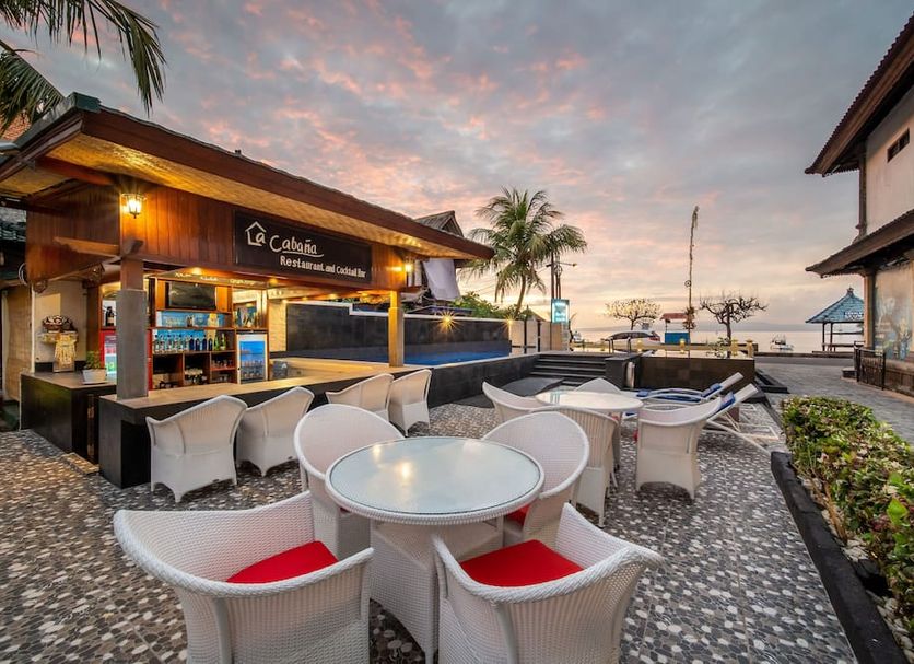 Absolute Scuba Bali Dive Resort in Manggis with outdoor seating overlooking the ocean at sunset