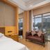 Lakeside Resort Jingdezhen room with sofa and lake and city view through sliding glass doors