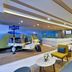 Citadines Sukhumvit 11 Bangkok lobby with tuk-tuk seating, reception desk and yellow-blue lounge chairs