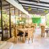 Howard Johnson by Wyndham Barranquilla Versalles outdoor dining area with glass walls and greenery in Barranquilla