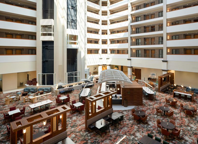 Embassy Suites by Hilton Charleston Airport Hotel & Convention Center atrium with dining tables in North Charleston