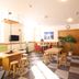 Lodge Koropokkuru in Niseko breakfast room with tables, stools, and checkered flooring