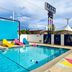 Hotel Zazz Albuquerque outdoor pool with colorful loungers and large blue shade screen