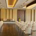 Hilton Frankfurt Gravenbruch meeting room in Neu Isenburg with rows of white chairs and a small stage