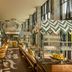 W Algarve Albufeira restaurant interior with bar seating, chevron awnings and fruit displays