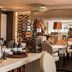 Golden Tulip Leiden Centre restaurant with set tables, wine display and warm modern dining room