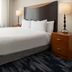 Fairfield Inn & Suites by Marriott Santa Maria guest room with king bed and bedside lamps