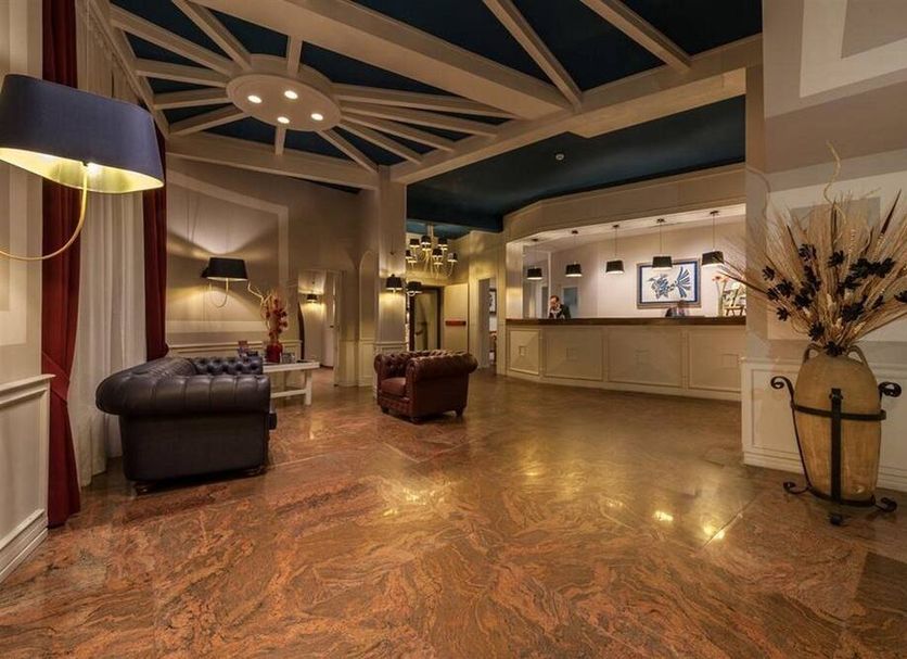 Bajamar Beach Hotel Formia lobby with reception desk, seating area, and polished marble floor
