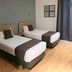 Hospedium Hotel Vittoria Colonna room in Medina de Ríoseco with two single beds and dark curtains