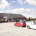 Rasta Arboga hotel exterior with restaurant, parking lot, and several parked cars in Arboga