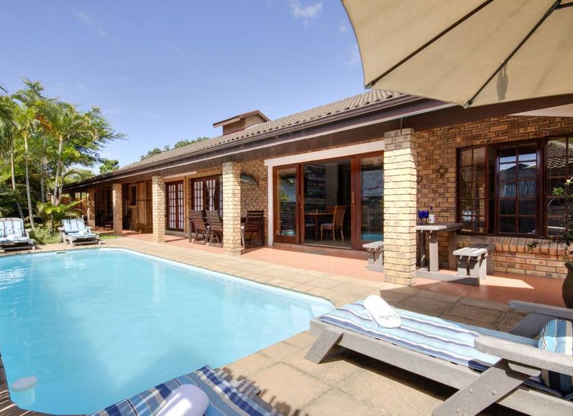 Marlin Lodge St Lucia in Saint Lucia with outdoor pool, sun loungers, and patio beside the lodge