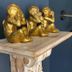 Sandway House Torquay shelf with three gold monkey figurines and wall sconces