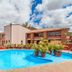 Villas del Sol Hotel & Bungalows in Oaxaca with a bright outdoor pool and terrace under a cloudy sky