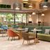 Home2 Suites by Hilton Xishuangbanna Jinghong lobby with green sectional seating and lounge chairs