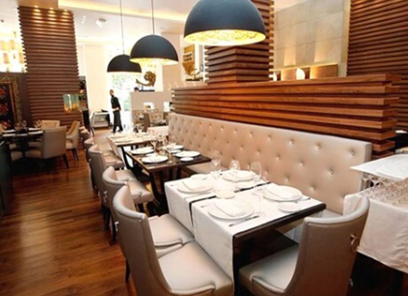 Gran Hotel Nagari Boutique & Spa in Vigo dining area with tufted banquette seating and pendant lights