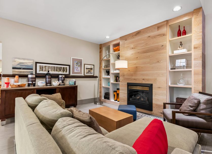 Country Inn & Suites by Radisson Chambersburg, PA lounge with fireplace, sectional sofa, and bar area