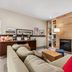 Country Inn & Suites by Radisson Chambersburg, PA lounge with fireplace, sectional sofa, and bar area