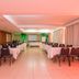 Hotel Embaixador Porto Alegre meeting room with rows of tables, chairs, and a projection screen