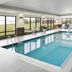 Indoor pool at Towneplace Suites By Marriott Danville with large windows and lounge seating