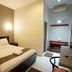 Patria Garden Hotel Blitar guest room with double bed, desk and air conditioner