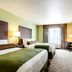 Cobblestone Hotel & Suites - Mccook guest room with two beds, TV, desk and window view in McCook