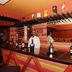 Hotel Goutham Manor bar in Chennai with a staff member behind a colorful lounge counter