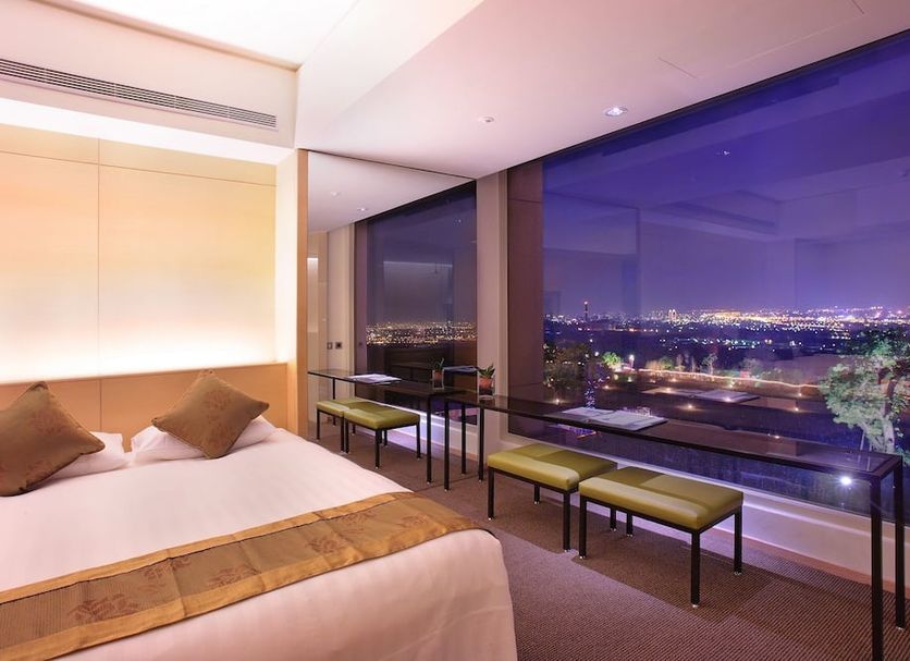 Freshfields Hotel in Taichung City room with large window and city night view