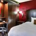 Hampton Inn Nashville-Vanderbilt guest room with bed, desk, chair, and warm wood paneling in Nashville