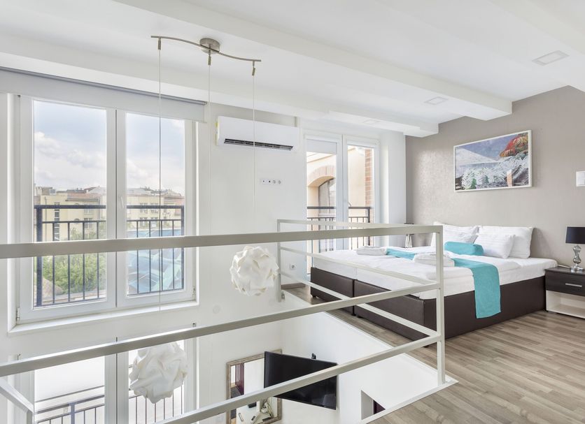 Hotel Mika Downtown Budapest loft-style room with large windows and balcony view