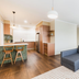 Statesman Hotel Canberra suite with kitchenette, dining table, and gray sectional sofa